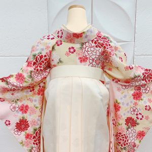クリーム×ピンクの可愛いらしい古典柄二尺袖に白袴の淡色コーデ。女の子らしい華やかさがインスタグラム映え。ネットショップでフルセットレンタル可能（後ろからの写真）